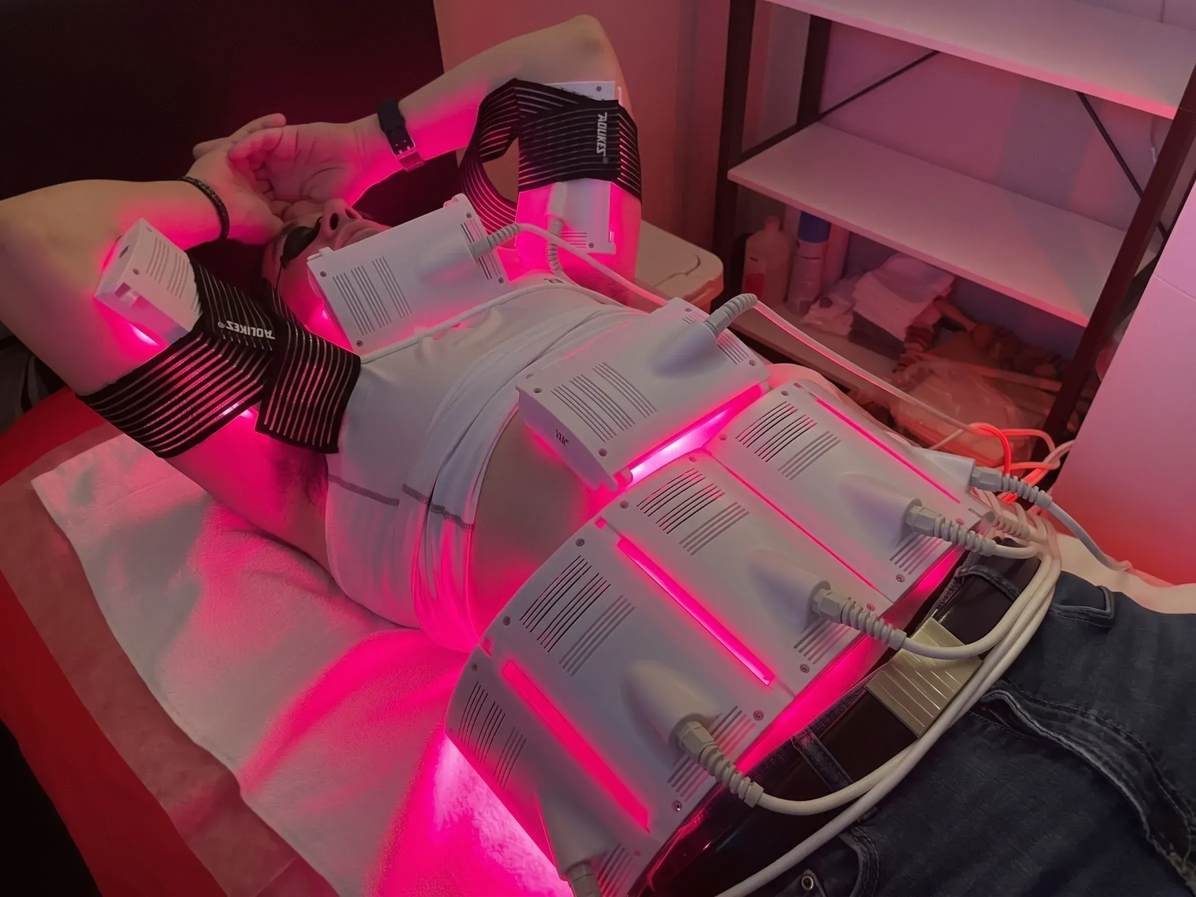 Red light therapy session at Aspire Trim Clinic in Charlotte, NC, client resting under the invisa-RED panel